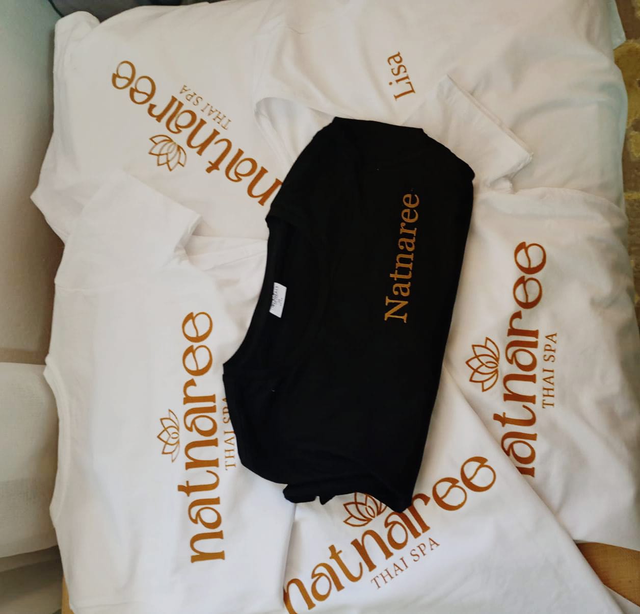 Natnaree Thai Spa uniforms with the signature lotus logo